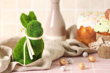Green Easter bunny and eggs on table
