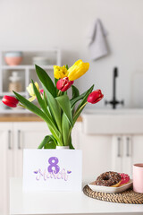 Beautiful tulips, breakfast and greeting card with text 8 MARCH on dining table. International Women's Day celebration
