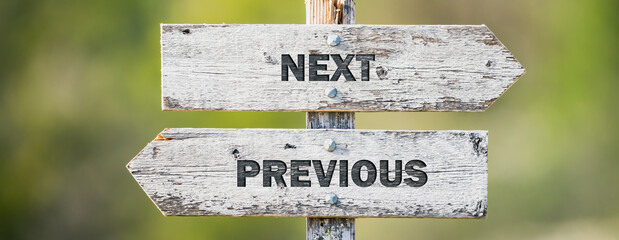 opposite signs on wooden signpost with the text quote next previous engraved. Web banner format. - obrazy, fototapety, plakaty