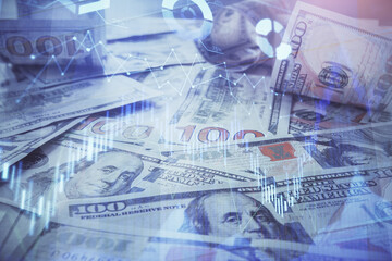 Multi exposure of forex chart drawing over us dollars bill background. Concept of financial success markets.