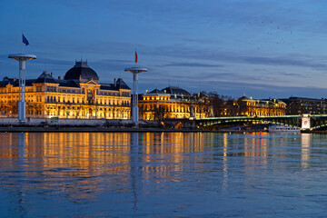 LYON, FRANCE, February 19, 2022 : Rhone river quays and University building at the blue hour.