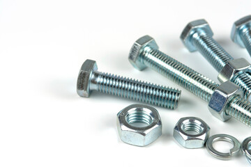metal bolts and nuts with round washers close-up on a white background. copy space
