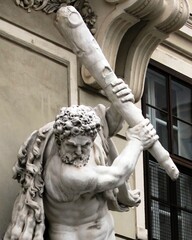 A statue depicting the ancient Greek hero Hercules and his exploits. Sculpture on the facade of a...