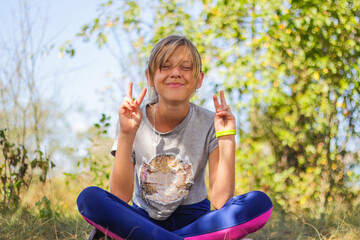 Defocus caucasian preteen girl practicing yoga in park, forest, outdoor, outside. Having fun,...