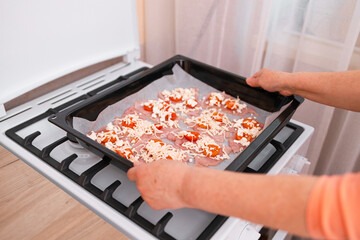 Chops. Woman hands put fresh turkey steaks meat on oven tray