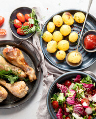 Baked chicken legs with salad and potatoes