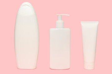 White containers for cosmetics. Body care. On a pink background.