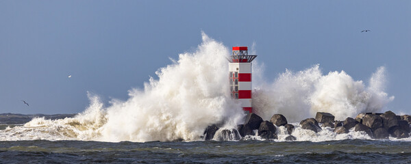 Lighthouse on the south pier in IJmuiden, Netherlands, being struck by big breaking waves caused by the storm Dudley in february 2022 © Simon van Hemert