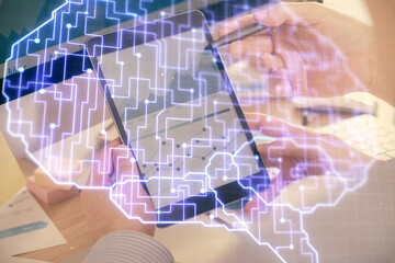 Double exposure of man's hand holding and using a digital device and brain hologram drawing. Data concept.