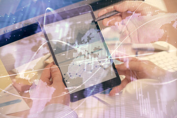 Double exposure of man's hands holding and using a phone and financial chart drawing. Market analysis concept.