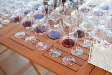 A lot of glasses with wine on the table for tasting