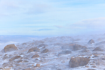 A scenic view of a snow storm in a Scottish mountain with high wind, snow and blizard conditions	
