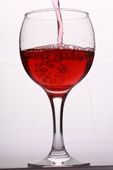red wine pours into the glass