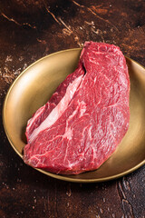 Marbled prime beef steak, raw top sirloin meat steak. Dark background. Top view