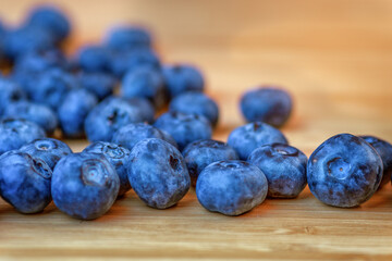 Blueberry berry close-up blueberry berries are lying on a wooden table. Close-up