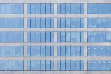 Fototapeta na wymiar Windows of business center tower in morning rays of sunlight