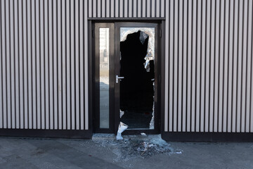 Broken glass door in shopping mall. Vandalism, burglary concept. Insurance concept. - obrazy, fototapety, plakaty