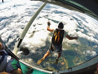 Skydiver jump out of plane over the beach - 488365123