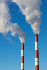 Power station smoke stacks against the blue sky