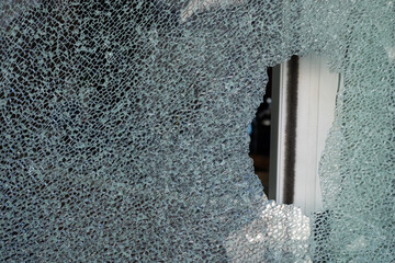 Cracked tempered glass with cracks pattern. Vandalism, destruction concept. Broken glass due to...