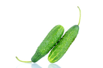 Two ripe green cucumbers, macro, isolated on white background.