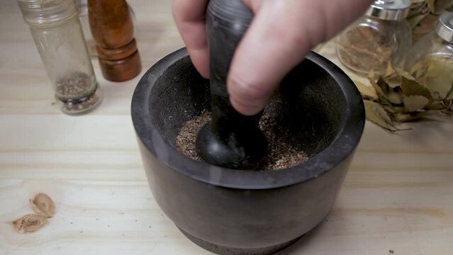 grinding peppercorns with mortar and pestle slow motion 4k