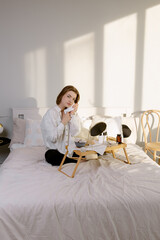 Girl holding a white towel near her face after cosmetic procedures