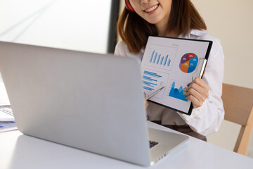 Woman working on laptop and giving presentations while online meeting. Work from home concept.