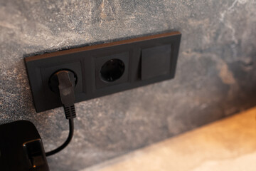 Close-up of black plug connected to socket.