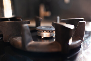 Close-up of gas burner with cast iron grate.