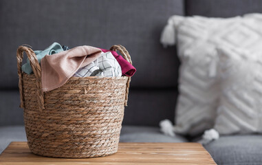 Household chores around the house. Washing clothes. A wicker basket with dirty laundry in the room...