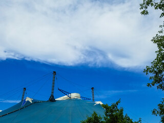 Circus tent under blue cloudy sky