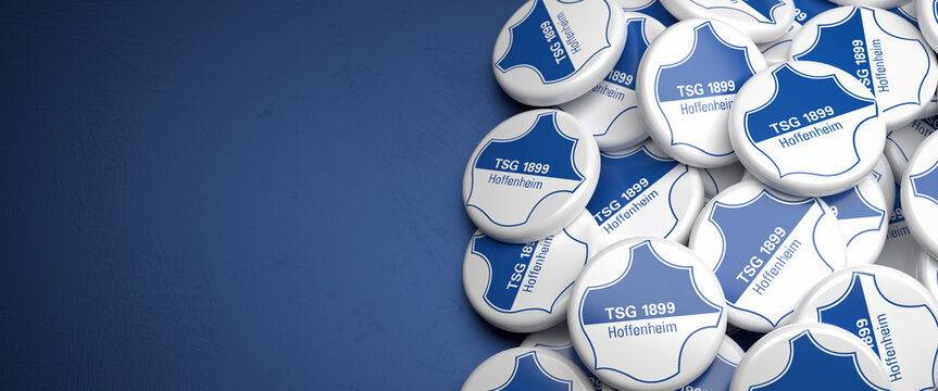 Logos of the German Soccer Club TSG Hoffenheim on a heap on a table. Copy space. Web banner format