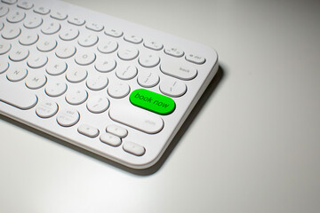 Close up of a Book Now button on a keyboard.