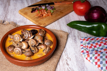 Snail stew, dish based on a sauce of vegetables and cooked snails.