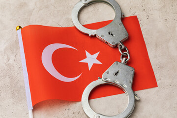 Turkish flag and handcuffs on an abstract background, the concept of crime in Turkish society