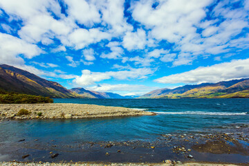 The lake Wanaka with pebbled shores