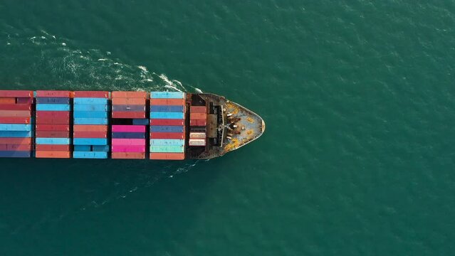 Aerial top view of cargo ship carrying container for import export goods send to customer from cargo yard port ,concept logistic and supply chain