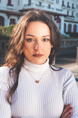 Young caucasian woman portrait standing in the middle of the street.