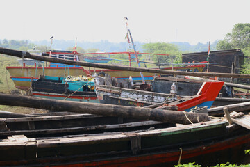Fototapeta na wymiar Wooden boats parked at dry land after fishing in India