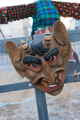 Traditional wooden devils mask on sale during Uzgavenes - obrazy, fototapety, plakaty