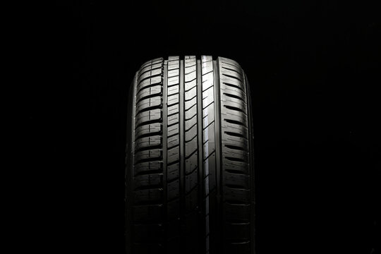 beautiful new summer tire on a black background. summer protector against aquaplaning and fuel economy