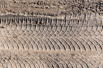 automobile tire marks on mud, tire marks on mud, tire tread marks on mud,