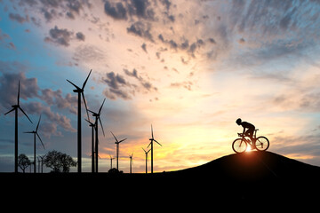 The concept of clean energy to save the world and the environment. Wind generators and cyclists