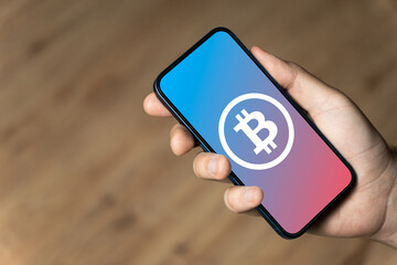 Bitcoin - hand holding a phone