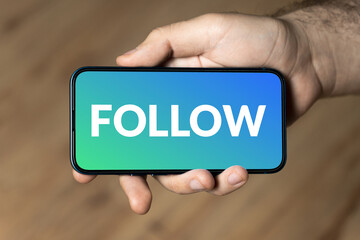 Follow - hand holding a phone