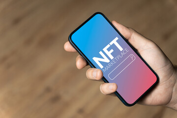 NFT marketplace - hand holding a phone