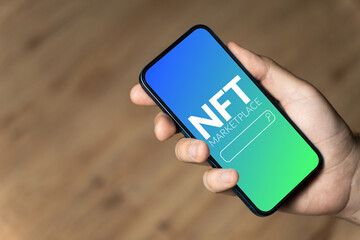 NFT marketplace - hand holding a phone