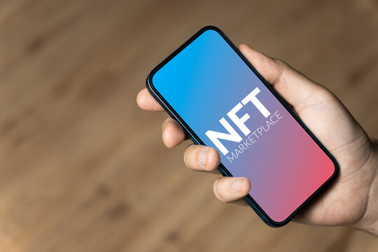 NFT marketplace - hand holding a phone