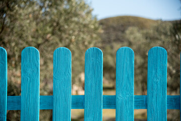 blue fence in the middle of the field
